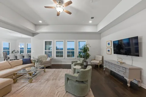 a living room with fireplace furniture and a large window