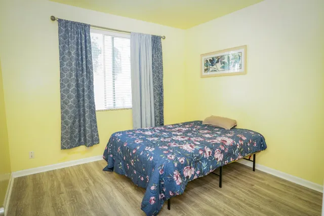 a bedroom with a bed and a window