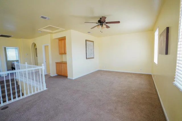 a view of a room with a ceiling fan