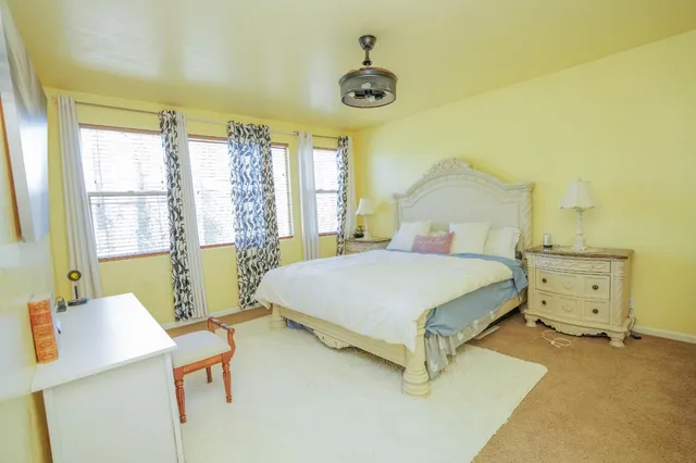 a bedroom with a bed and a table