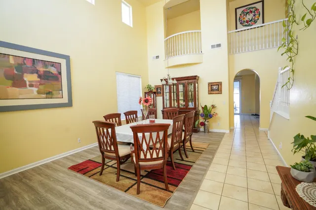 a dining room with furniture and wooden floor