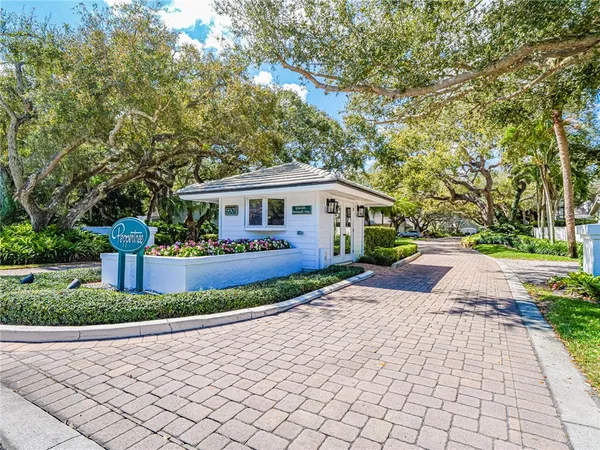 a front view of a house with a yard and a garden