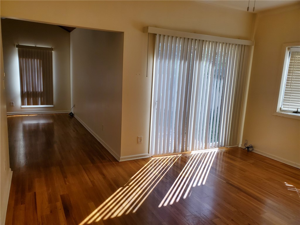 131 Peppertree Drive, Unit 21 Vero Beach, FL 32963 - Photo 15 of 25 a view of a room with wooden floor and windows
