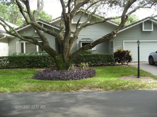 131 Peppertree Drive, Unit 21 Vero Beach, FL 32963 - Photo 24 of 25 a house that has a tree in front of it