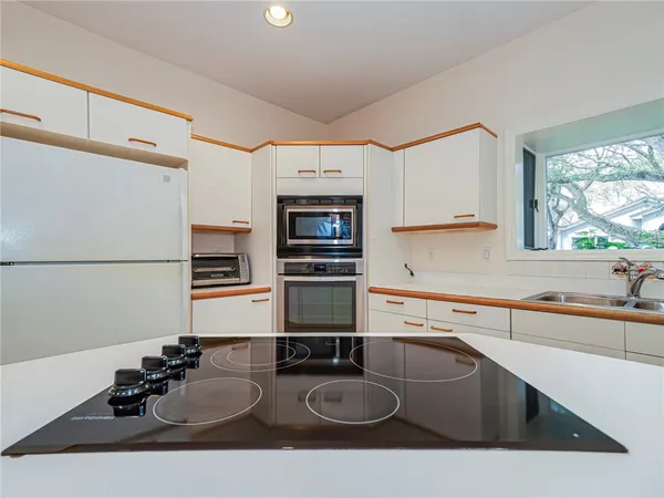 a view of a room with wooden floor and chandelier
