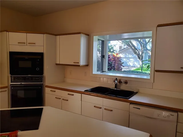 a kitchen with stainless steel appliances a sink stove and refrigerator