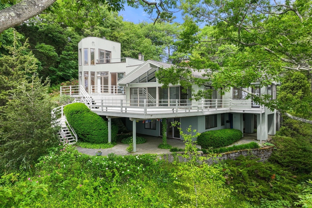 a view of house with a yard and sitting area