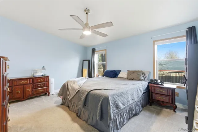 a bedroom with a bed dresser and a window