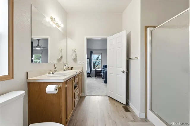 a en suite bathroom with a sink mirror and toilet