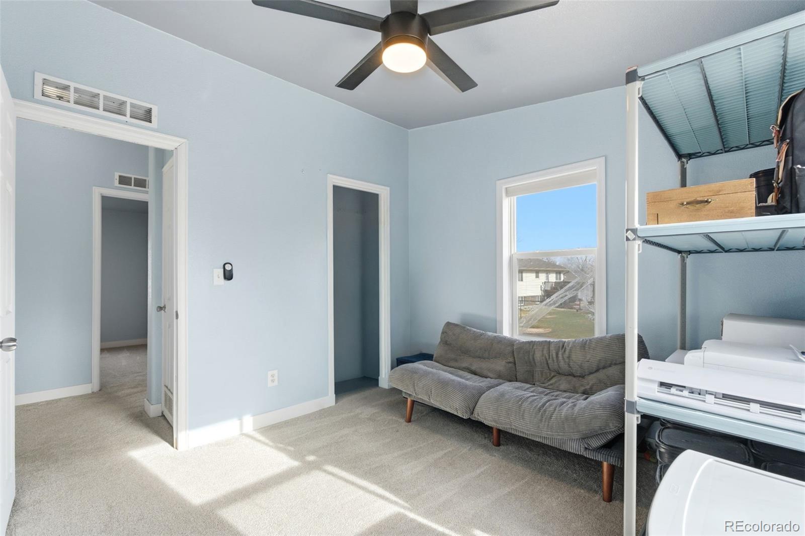 8137 Lafayette Street Denver, CO 80229 - Photo 22 of 36 a living room with furniture and a window