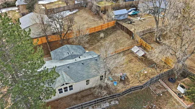 an aerial view of a house with a yard and trees