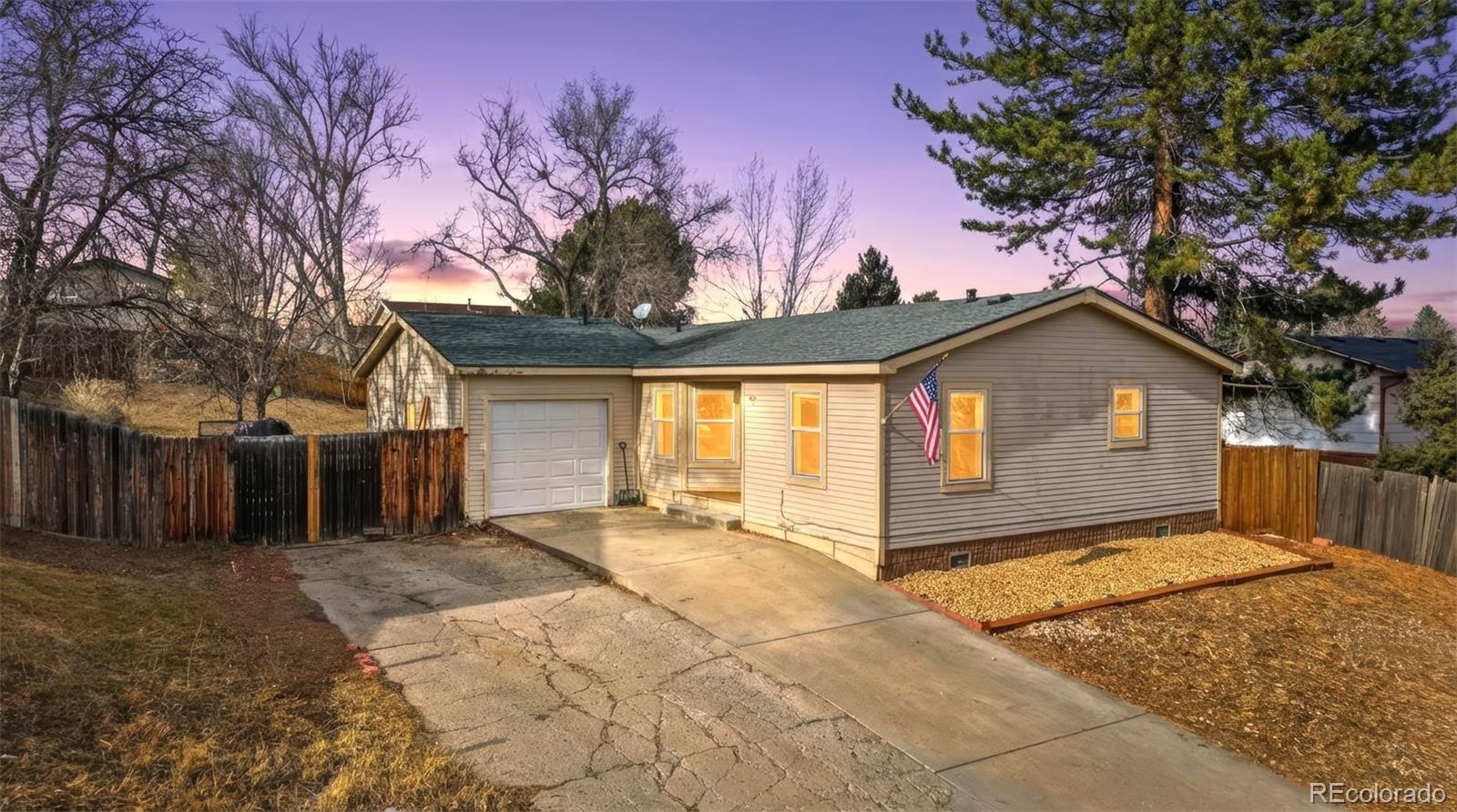 8137 Lafayette Street Denver, CO 80229 - Photo 35 of 36 a view of a house with a large tree and wooden fence