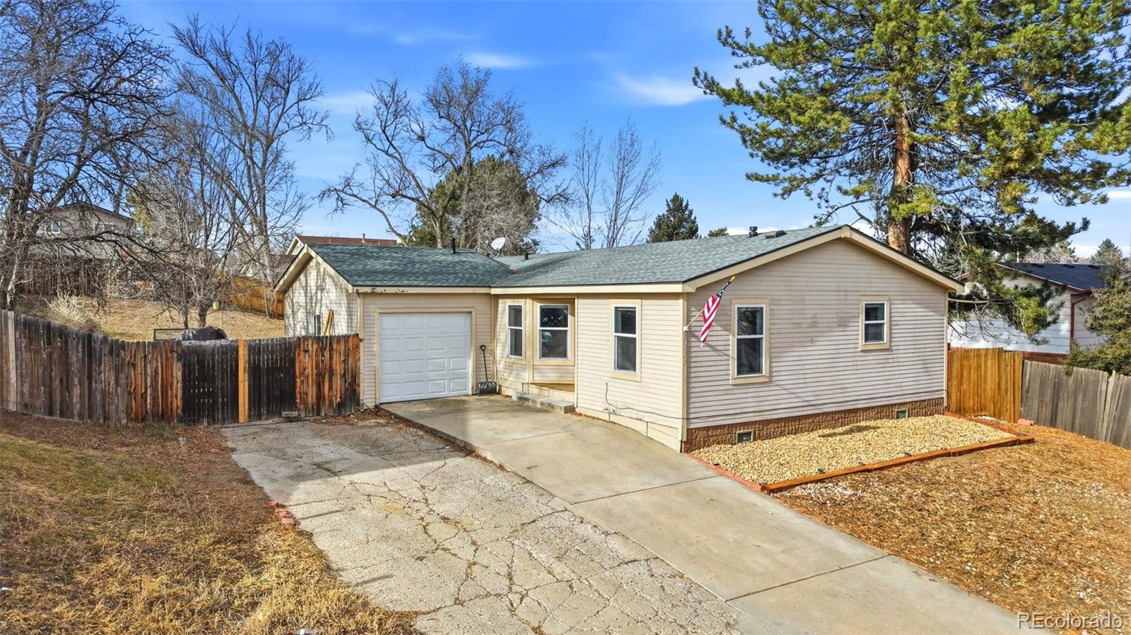 8137 Lafayette Street Denver, CO 80229 - Photo 36 of 36 a view of a house with a large tree and wooden fence