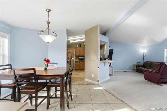 a dining room with furniture and window