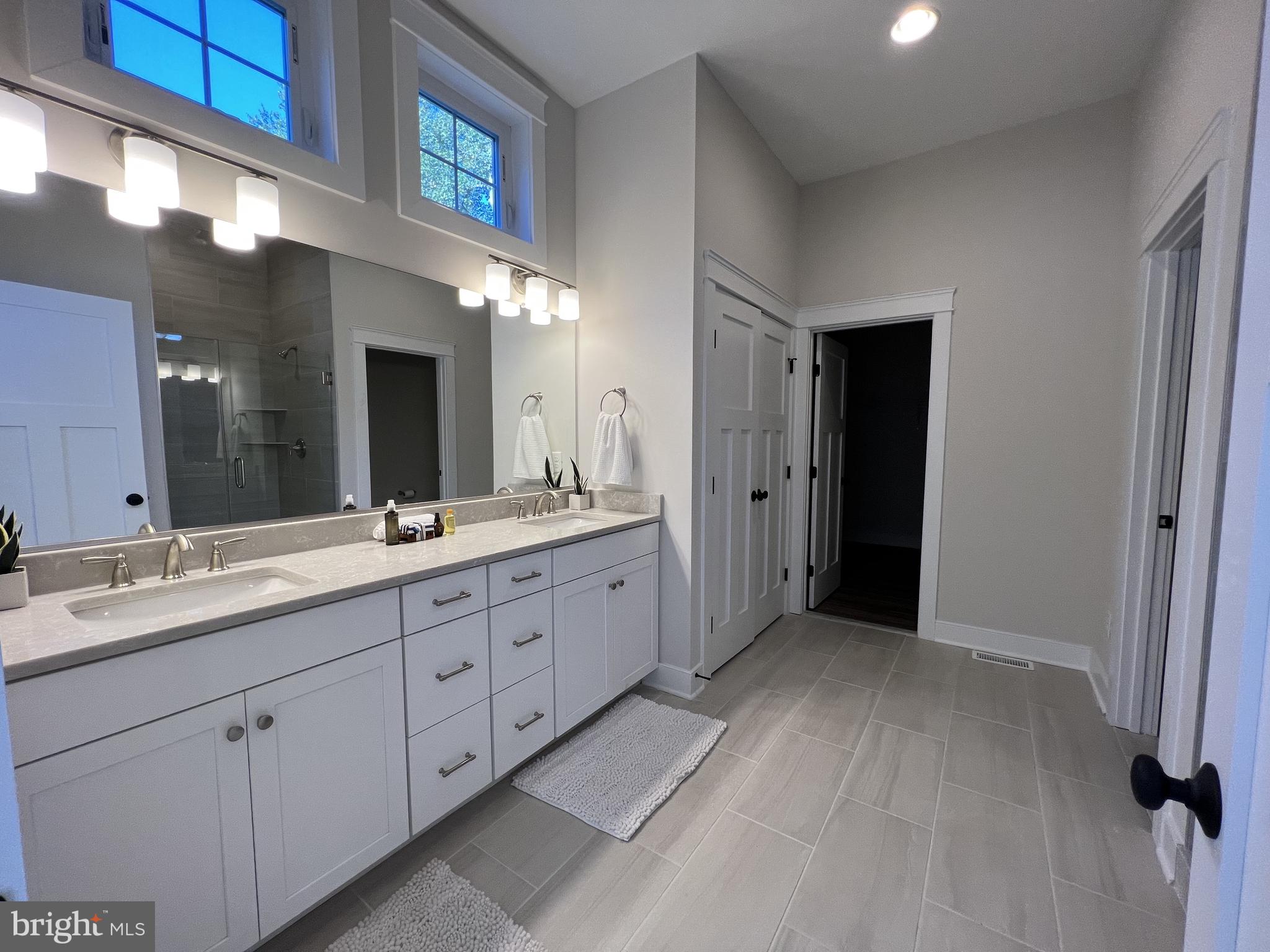 30491 Blue Beech Lane Frankford, DE 19945 - Photo 13 of 17 a spacious bathroom with a double vanity sink and a mirror