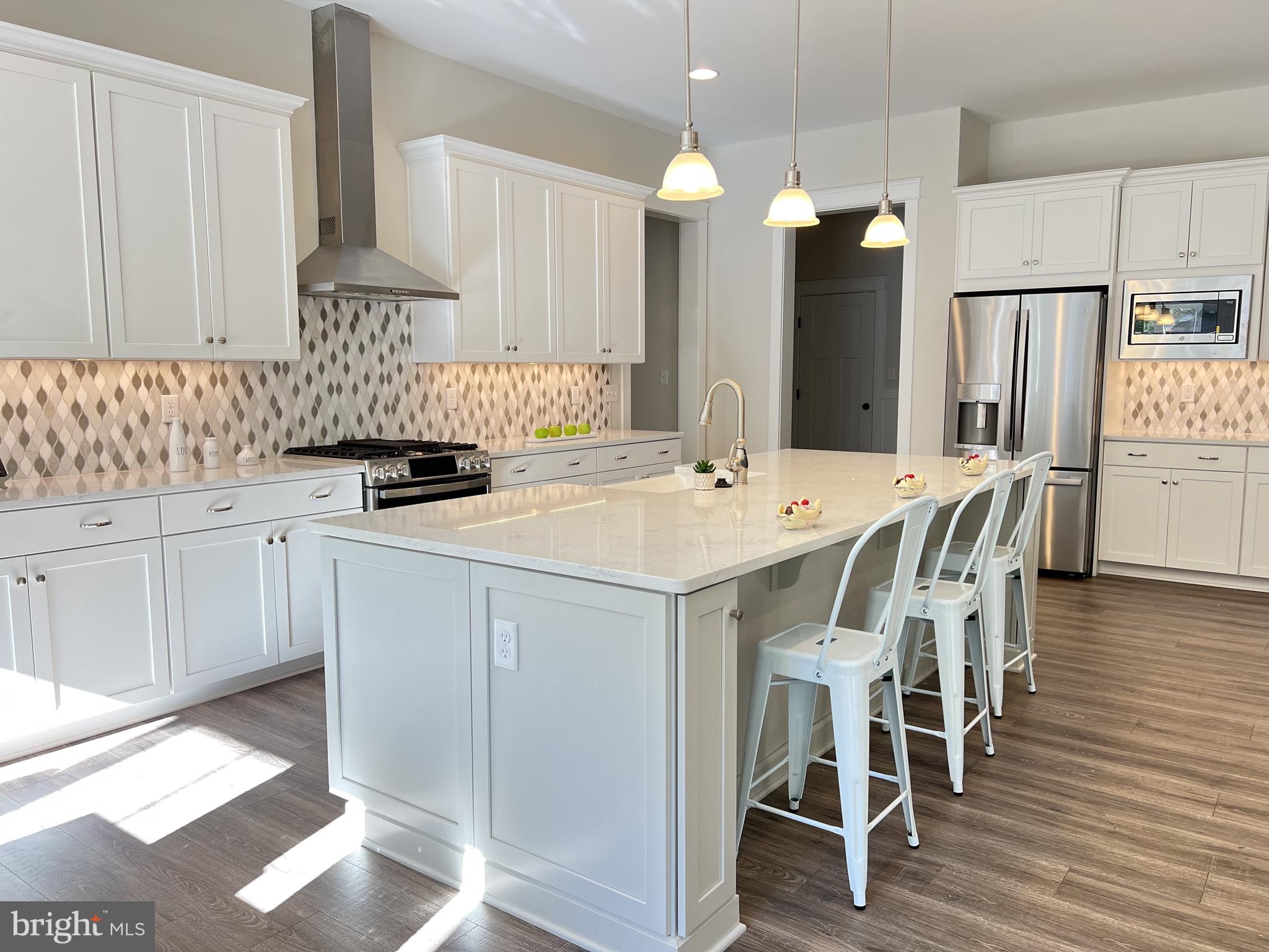 30491 Blue Beech Lane Frankford, DE 19945 - Photo 9 of 17 a kitchen with a sink a cabinets and chairs