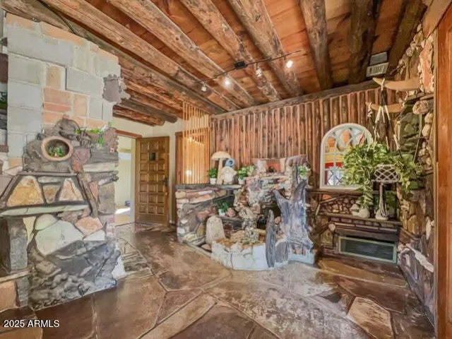 a living room with furniture a chandelier and a flat screen tv