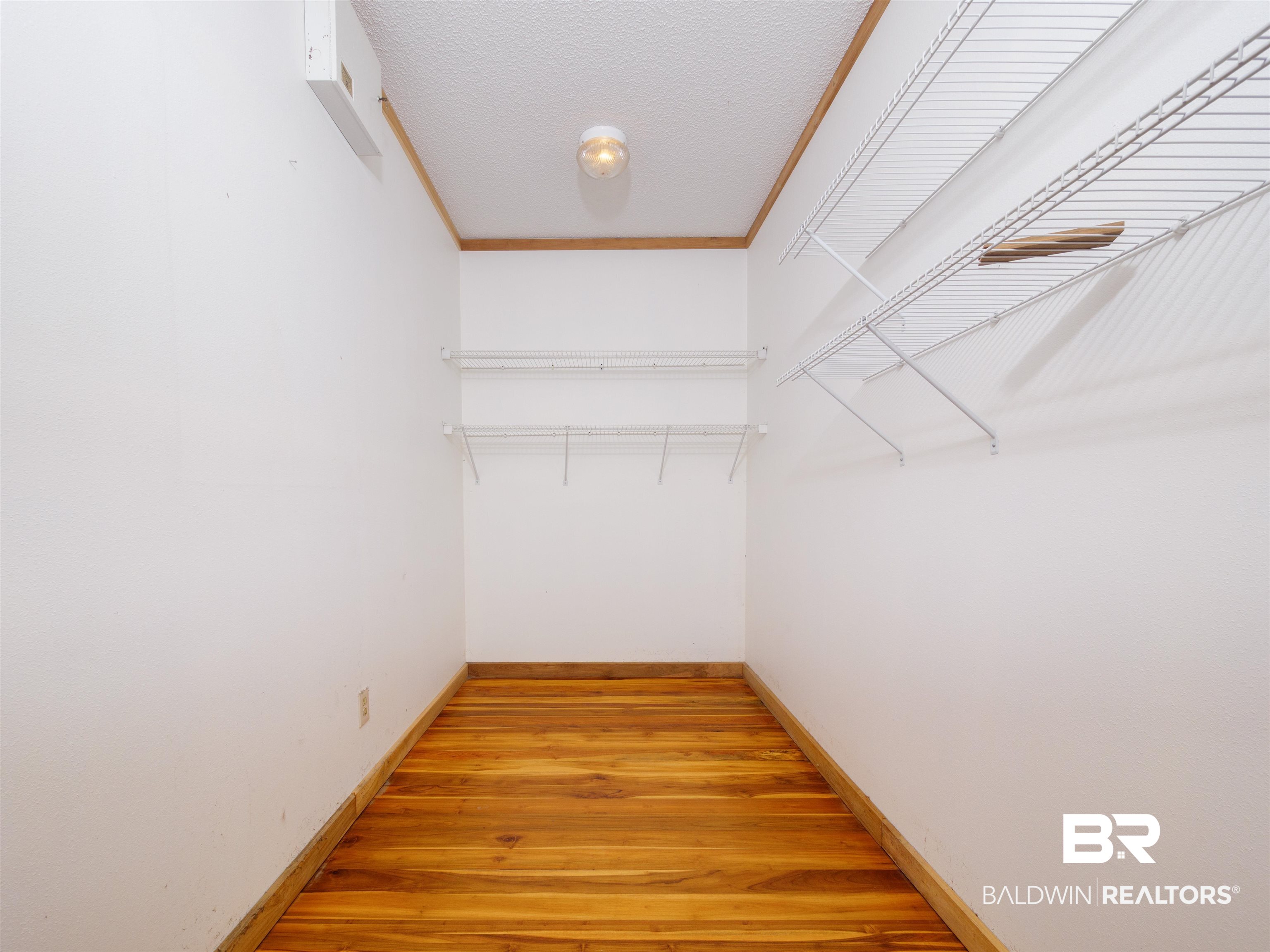 12831 Clay City Road Fairhope, AL 36532 - Photo 15 of 47 Oversized walk in closet with teak door