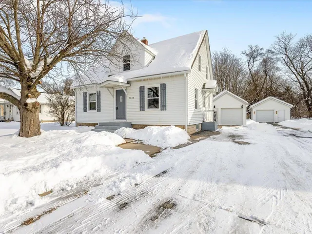 a view of a house with snow on the road
