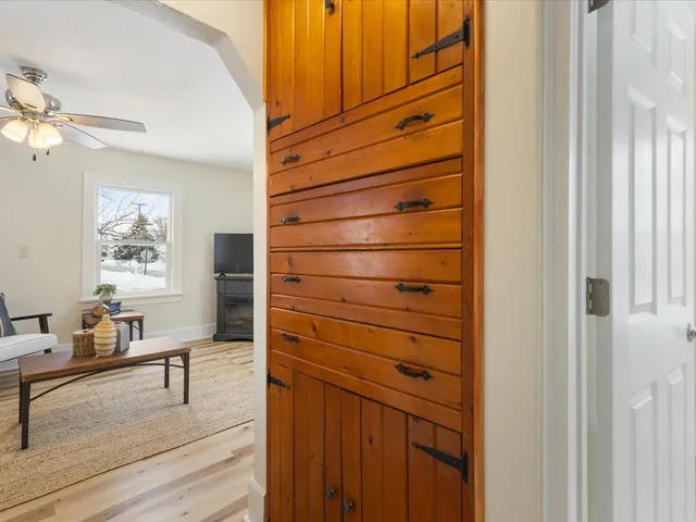 a view of a bedroom with furniture and wooden floor