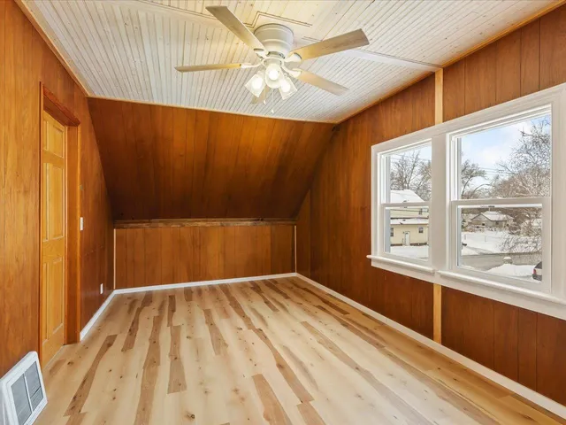 a view of a room with wooden floor and windows