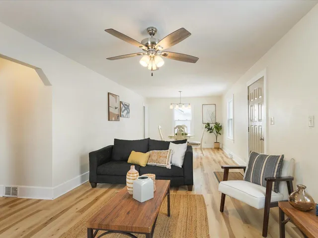 a living room with furniture and a chandelier