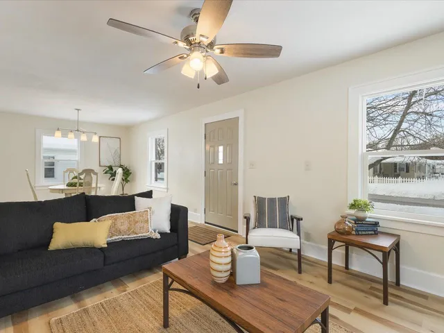 a living room with furniture and a chandelier