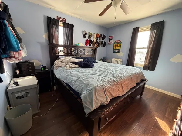 a bedroom with a bed and a television
