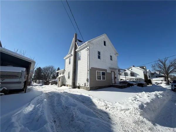 a view of large house with a snow in the background
