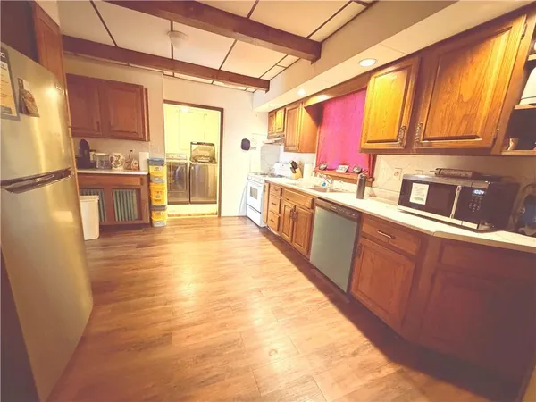 a kitchen with stainless steel appliances a refrigerator sink and cabinets