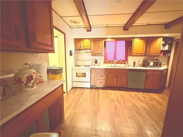 a kitchen with stainless steel appliances granite countertop a sink and cabinets