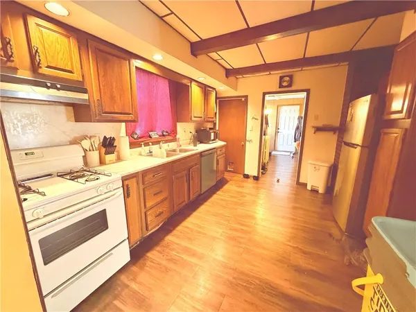 a kitchen with stainless steel appliances a stove a sink and a refrigerator