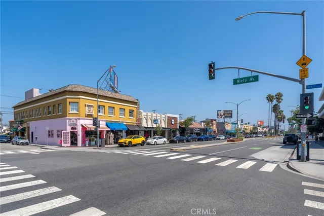 a front view of a building with cars