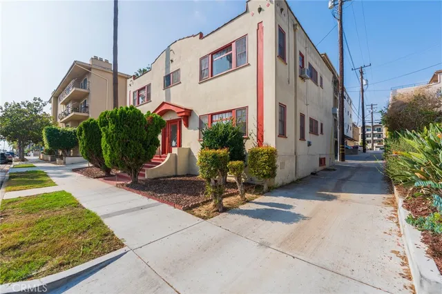 a view of a street with potted plants