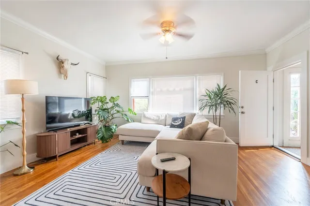 a living room with furniture and a wooden floor