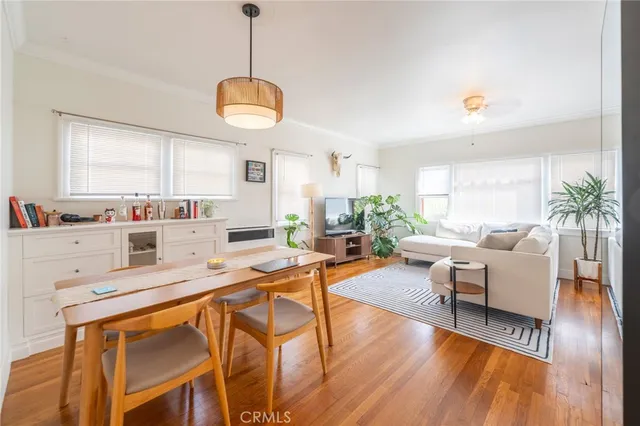 a living room with dining room and wooden floor