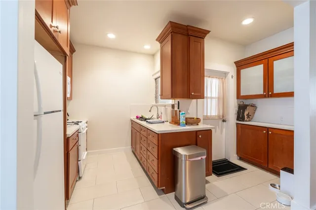 a kitchen with a sink stove and refrigerator