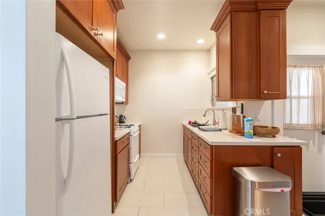 a kitchen with stainless steel appliances granite countertop a sink and a refrigerator
