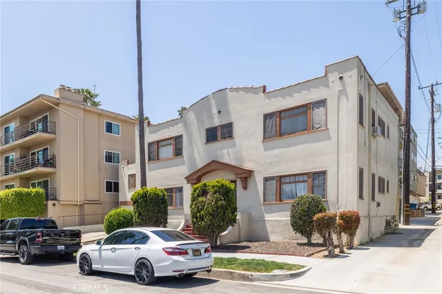 a front view of a building with car parked