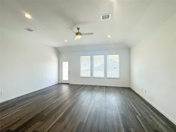 wooden floor in an empty room with a window