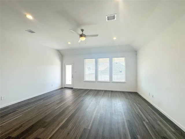 an empty room with a empty space and windows