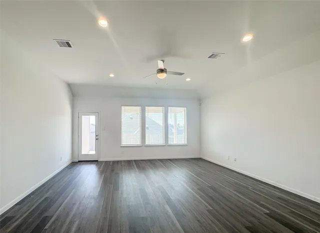 an empty room with a empty space and windows