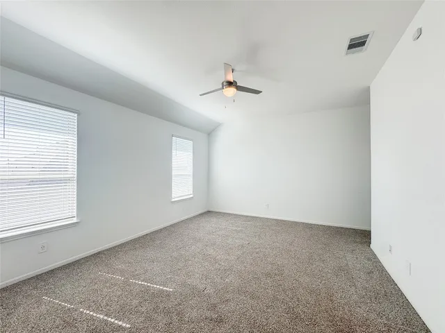 a view of a backyard with a wooden fence