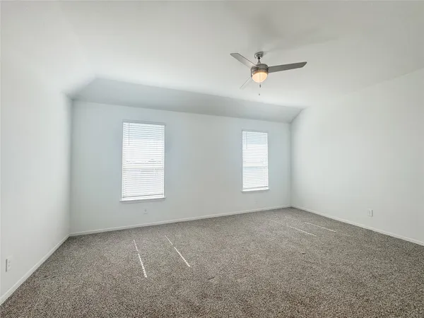 an empty room with a window and a ceiling fan