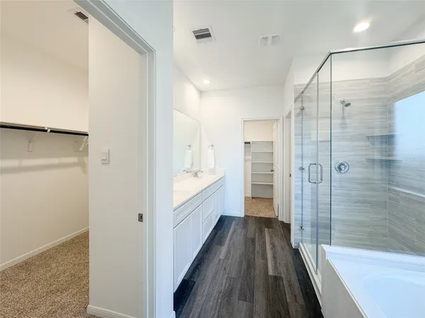a bathroom with a bathtub and a shower