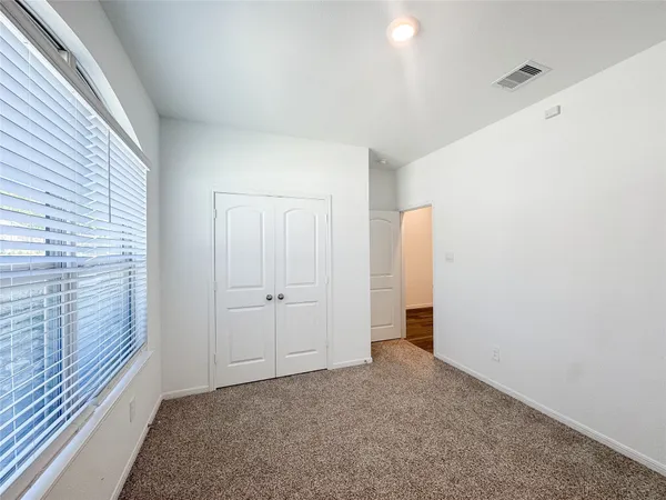 an empty room with a empty space and windows