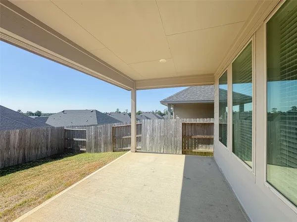 a view of a backyard with a wooden fence