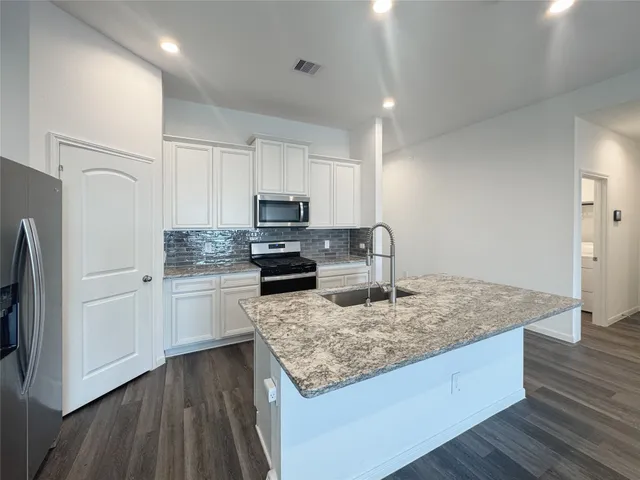 a spacious bathroom with a double vanity sink a mirror and a shower