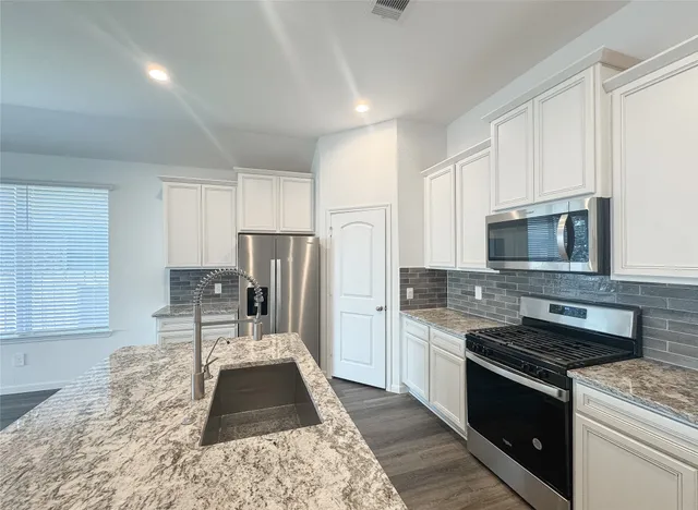 a spacious bathroom with a tub sink shower and mirror