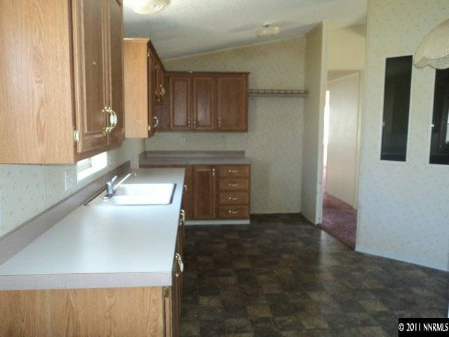 5600 West Ranger Road Reno, NV 89506 - Photo 5 of 10 a view of a kitchen with an empty space and a window